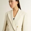 Blazer de mujer en mezcla de lana a rayas blancas y grises con mangas cortas. Blazer de mujer en mezcla de lana a rayas blancas y grises con mangas cortas.