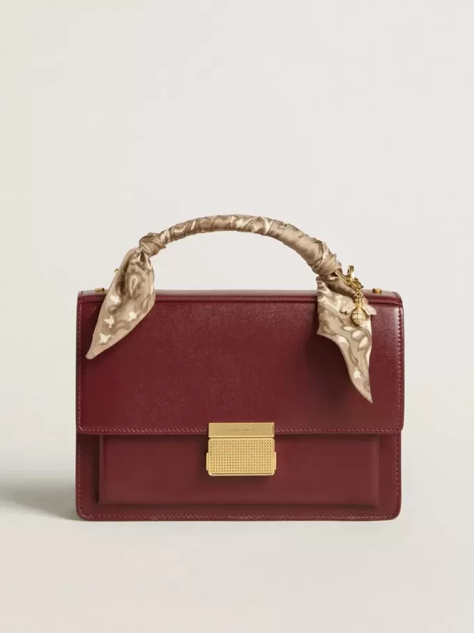 Bolso Venezia en piel bordada burdeos con detalles dorados