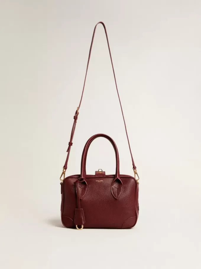 Bolso Vita en piel burdeos con detalles dorados Bolso Vita en piel burdeos con detalles dorados