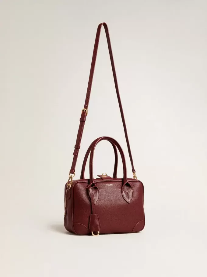 Bolso Vita en piel burdeos con detalles dorados Bolso Vita en piel burdeos con detalles dorados