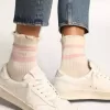 Calcetines blancos con acabado desgastado, logotipo rosa claro y rayas. Calcetines blancos con acabado desgastado, logotipo rosa claro y rayas.