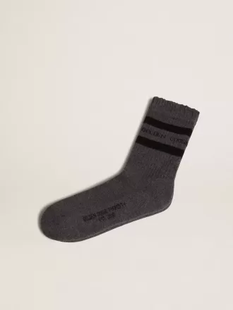 Calcetines grises con detalles desgastados y rayas negras.
