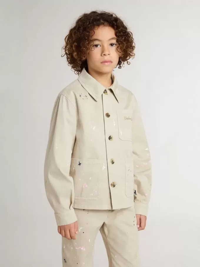 Chaqueta beige para niño con salpicaduras multicolores