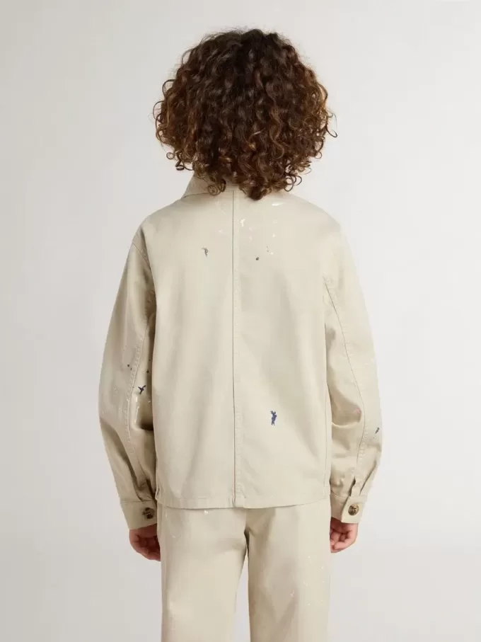Chaqueta beige para niño con salpicaduras multicolores