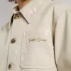 Chaqueta beige para niño con salpicaduras multicolores