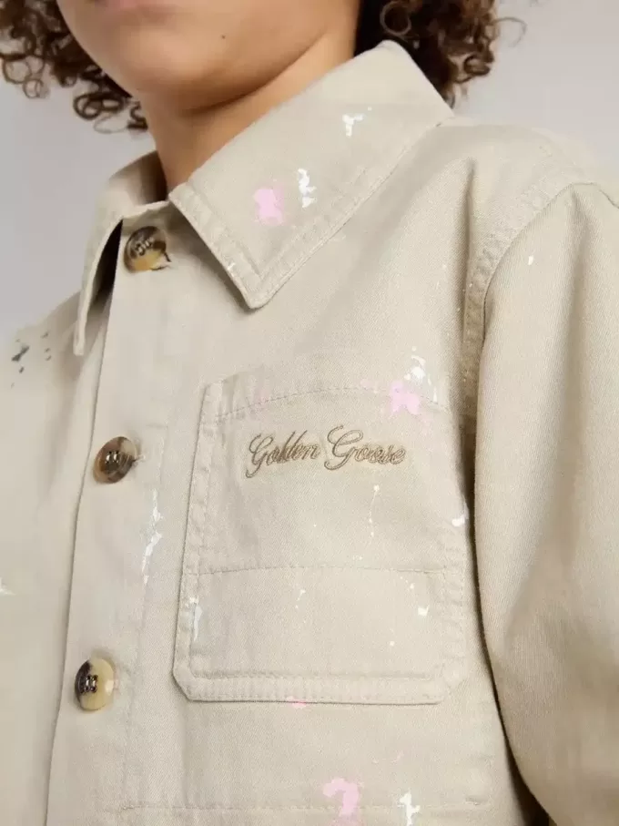 Chaqueta beige para niño con salpicaduras multicolores