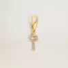 Colgante con forma de llave en latón dorado con cristales Colgante con forma de llave en latón dorado con cristales
