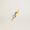 Colgante con forma de llave en latón dorado con cristales Colgante con forma de llave en latón dorado con cristales