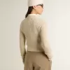 Jersey corto de cuello redondo en lana beige con cristales por toda la superficie Jersey corto de cuello redondo en lana beige con cristales por toda la superficie