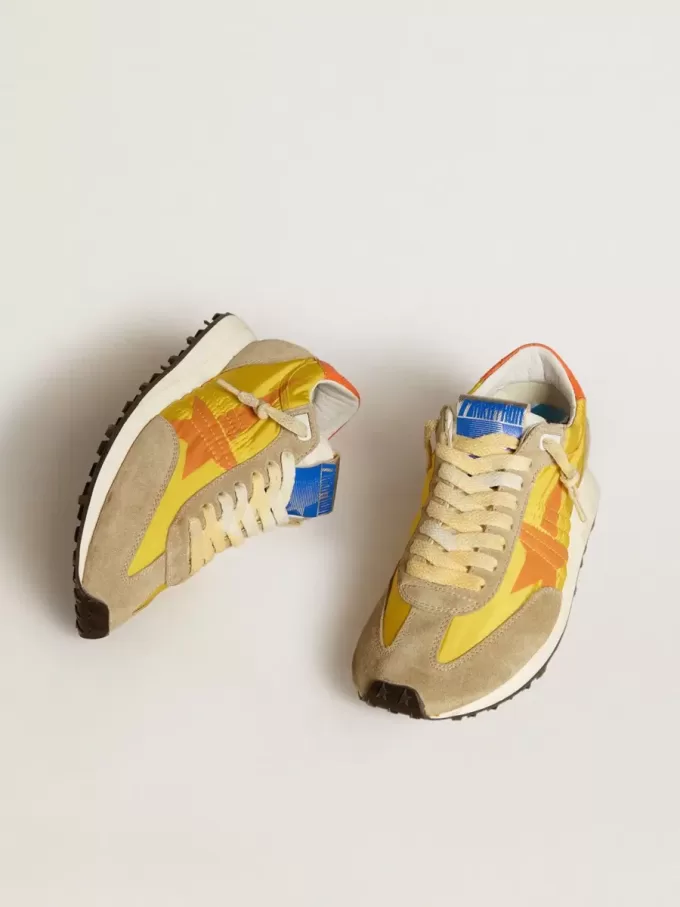 Marathon para mujer con parte superior de nailon amarillo y estrella naranja. Marathon para mujer con parte superior de nailon amarillo y estrella naranja.