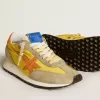 Marathon para mujer con parte superior de nailon amarillo y estrella naranja. Marathon para mujer con parte superior de nailon amarillo y estrella naranja.