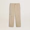 Pantalones chinos beige para niño con salpicaduras multicolores Pantalones chinos beige para niño con salpicaduras multicolores