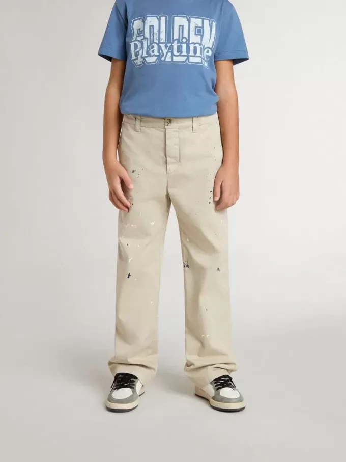 Pantalones chinos beige para niño con salpicaduras multicolores Pantalones chinos beige para niño con salpicaduras multicolores