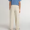 Pantalones chinos beige para niño con salpicaduras multicolores Pantalones chinos beige para niño con salpicaduras multicolores
