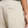 Pantalones chinos beige para niño con salpicaduras multicolores Pantalones chinos beige para niño con salpicaduras multicolores