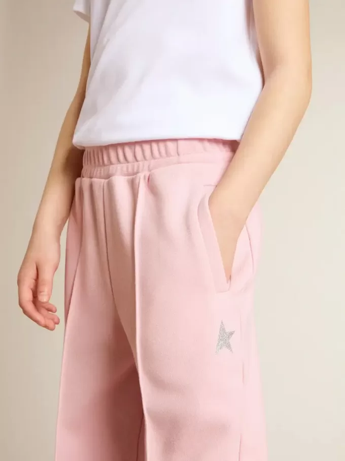 Pantalones de chándal rosas con estrella brillante en la parte delantera. Pantalones de chándal rosas con estrella brillante en la parte delantera.