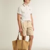 Polo de hombre en punto perforado blanco con detalles de rayas burdeos