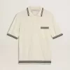 Polo de punto blanco desgastado para hombre con ribetes azules Polo de punto blanco desgastado para hombre con ribetes azules