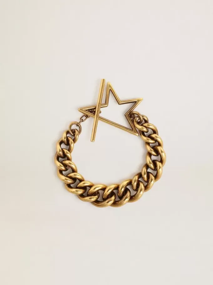 Pulsera con cadena decreciente en oro antiguo y cierre en forma de estrella Pulsera con cadena decreciente en oro antiguo y cierre en forma de estrella