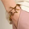Pulsera con cadena decreciente en oro antiguo y cierre en forma de estrella Pulsera con cadena decreciente en oro antiguo y cierre en forma de estrella