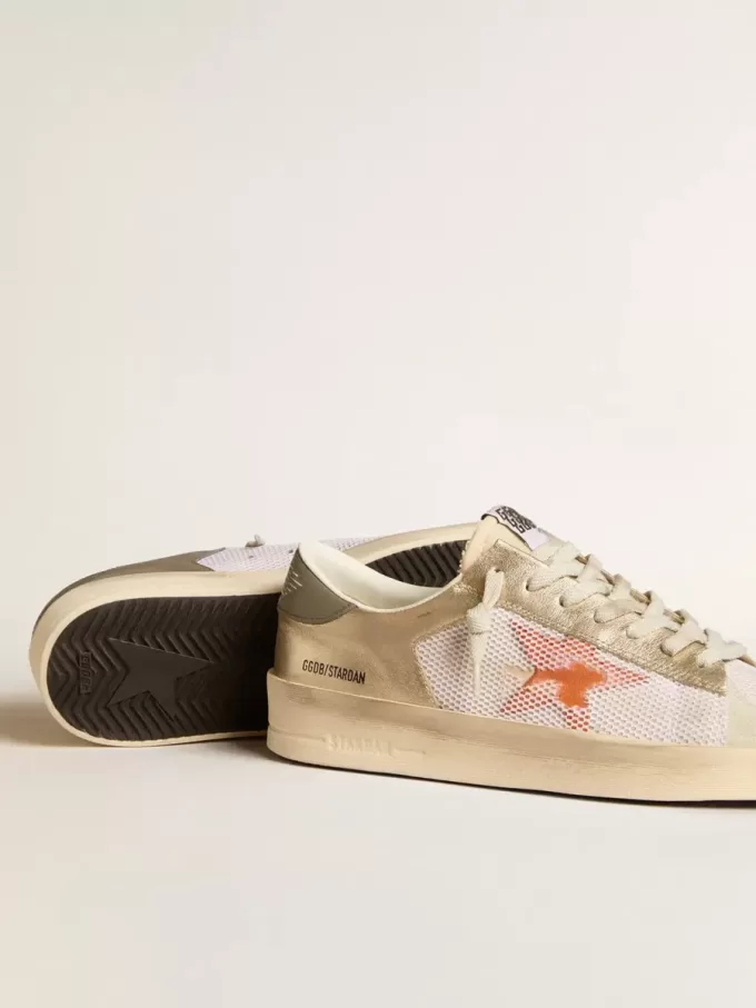 Stardan en malla blanca con estrella naranja e inserciones de piel platino Stardan en malla blanca con estrella naranja e inserciones de piel platino