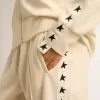 Sudadera blanca con cremallera para mujer con franja blanca y estrellas negras Sudadera blanca con cremallera para mujer con franja blanca y estrellas negras