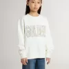 Sudadera blanca para niña con inscripción multicolor «Golden» en la parte delantera Sudadera blanca para niña con inscripción multicolor «Golden» en la parte delantera