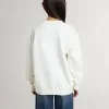 Sudadera blanca para niña con inscripción multicolor «Golden» en la parte delantera Sudadera blanca para niña con inscripción multicolor «Golden» en la parte delantera