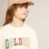 Sudadera en blanco desgastado con letras doradas multicolores en la parte delantera