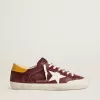 Super-Star para hombre en ante rojo ladrillo con estrella de cuero blanco y lengüeta del talón con estampado animal.