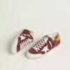 Super-Star para hombre en ante rojo ladrillo con estrella de cuero blanco y lengüeta del talón con estampado animal.