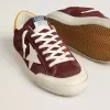 Super-Star para hombre en ante rojo ladrillo con estrella de cuero blanco y lengüeta del talón con estampado animal.