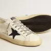 Super-Star para hombre en piel blanca con estrella de lona azul medianoche y lengüeta del talón en piel color tabaco. Super-Star para hombre en piel blanca con estrella de lona azul medianoche y lengüeta del talón en piel color tabaco.