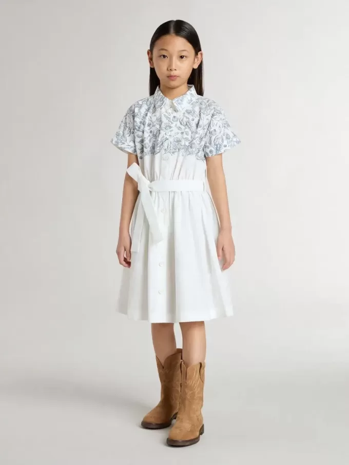 Vestido camisero para niña en lona de algodón blanca con estampado náutico azul y ribetes blancos Vestido camisero para niña en lona de algodón blanca con estampado náutico azul y ribetes blancos