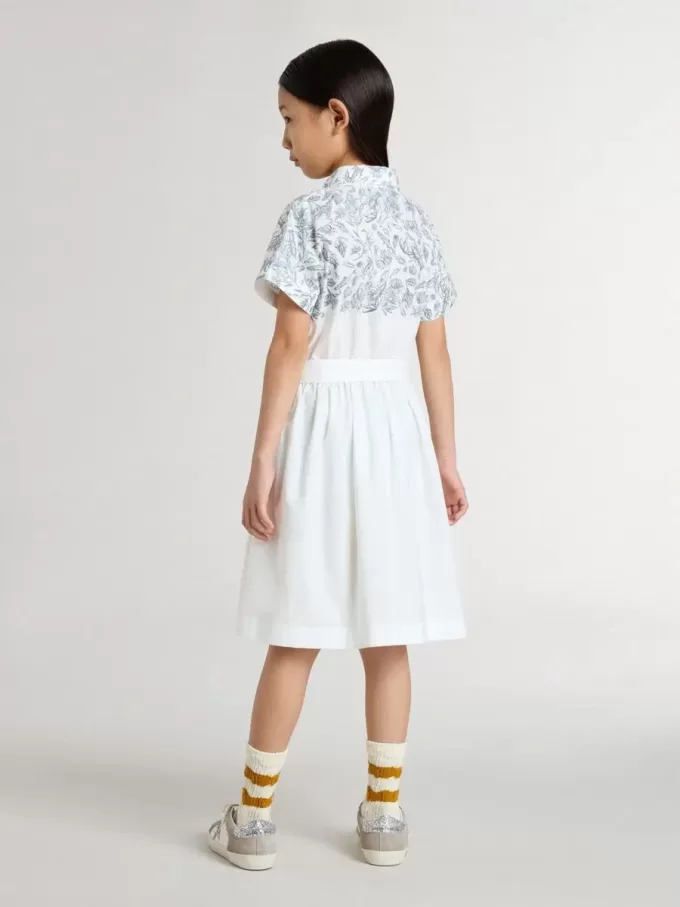 Vestido camisero para niña en lona de algodón blanca con estampado náutico azul y ribetes blancos Vestido camisero para niña en lona de algodón blanca con estampado náutico azul y ribetes blancos